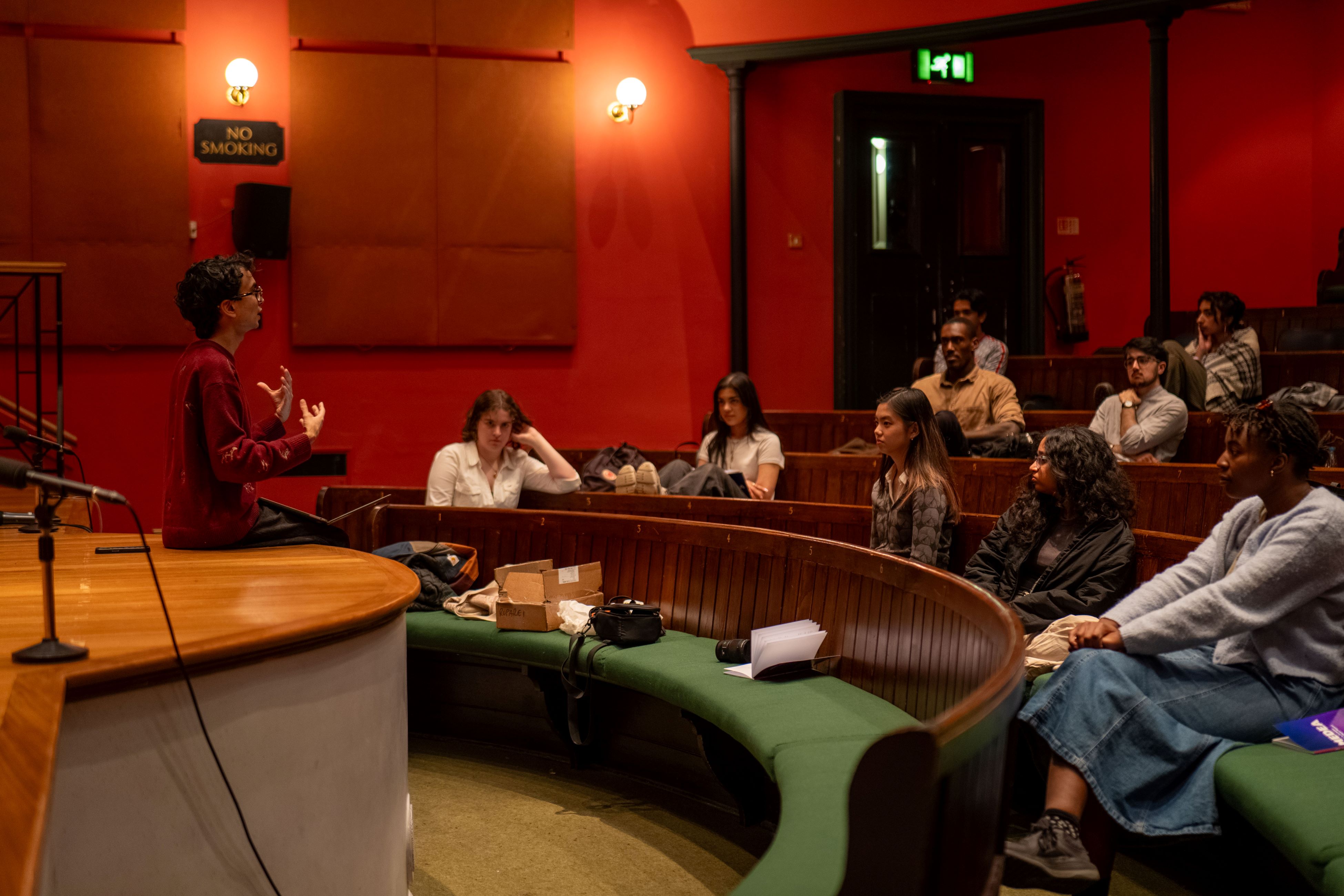 The cast and crew discuss notes and ideas with Dhyan Ruparel during rehearsals at Pembroke College Theatre